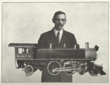 A.D. Baker holding a model of His Locomotive